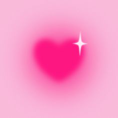 a heart shaped object with a white star in the center on a pink background that appears to be blurry