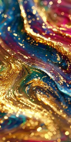 an abstract painting with gold, blue and pink colors on it's surface is shown in close up