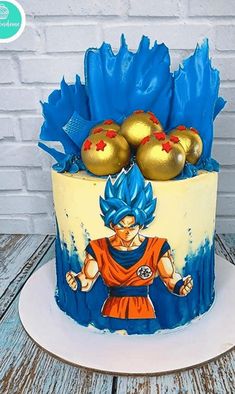 a birthday cake decorated with an image of gohan and gold balls on top of it