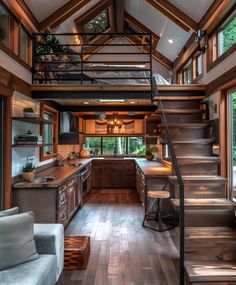 an open concept kitchen and living room with stairs leading up to the upper floor area