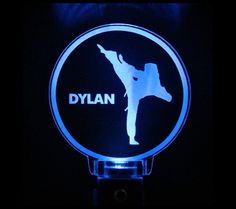 a blue illuminated sign with a silhouette of a person doing karate