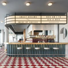 the inside of a restaurant with red and white checkered flooring on the walls