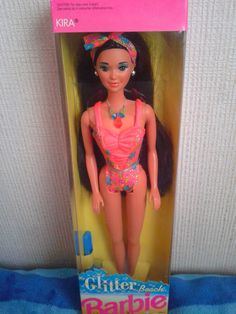 a barbie doll in a pink swimsuit and headband