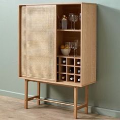 a wooden cabinet with wine glasses on it