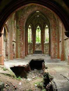 an old church with broken windows and debris on the ground