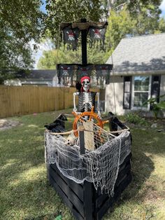 a pirate ship made out of pallets in the yard with halloween decorations around it