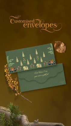 two green envelopes with trees and animals on them, one is for someone's wedding