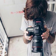 a man holding a camera in front of his face