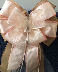 a pink and tan bow with polka dots on it