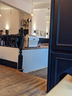 a man standing in front of a counter with a camera on it's side