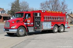 a red fire truck is parked on the street