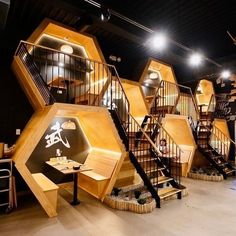 a room filled with lots of wooden stairs and tables next to each other on top of cement floors