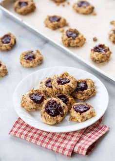 cookies with jam are on a white plate