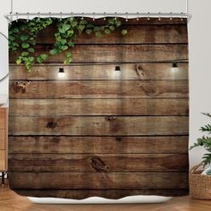 a shower curtain with wooden planks and plants growing on the outside, along with lights