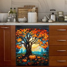 the kitchen counter is decorated with an autumn tree and pumpkins, as well as other items