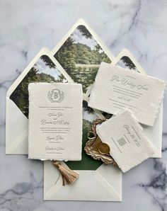 the wedding stationery is laid out on top of an envelope and some other items