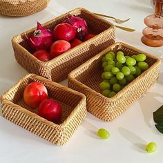 three baskets filled with fruit sitting on top of a white table next to green beans