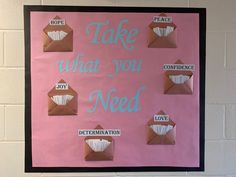 a pink bulletin board with brown envelopes and words on it that say, take what you need