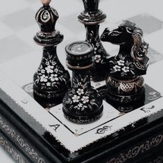 a black and white chess set on a checkered board