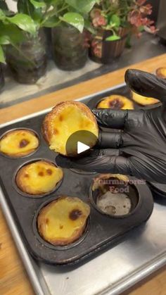 a person in black gloves is baking some food