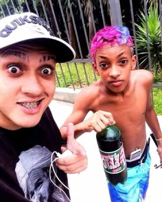 two kids with pink hair and one is holding a bottle