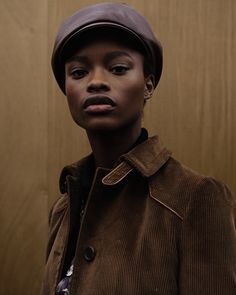 a woman wearing a brown hat and jacket