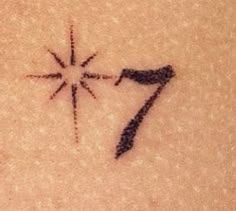 a tattoo with the number seven drawn on it's back and an arrow in the middle