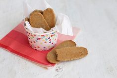 some cookies are in a paper cup on a napkin