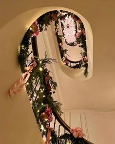 a staircase decorated with christmas decorations and lights