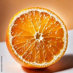 an orange cut in half sitting on top of a table