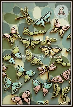 many different colored butterflies on a green and blue background