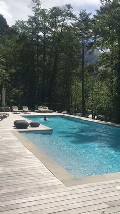 an empty swimming pool surrounded by trees