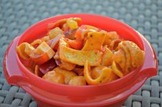 a red bowl filled with food on top of a table