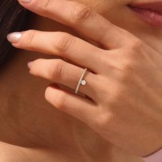 a close up of a person wearing a diamond ring