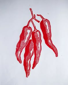 three chili peppers hanging from a branch on a white background with red ink in it