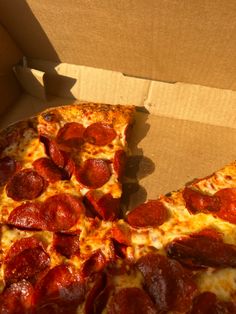 a slice of pepperoni pizza in a box