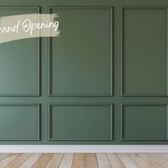 an empty room with green walls and wood flooring that says grand opening on the wall