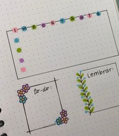 an open planner with flowers and letters on it, next to a marker board that says lemonade