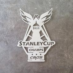 the stanley cup champs logo is shown on a metal surface with white lettering and an eagle