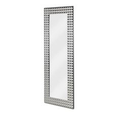 a mirror that is sitting on top of a white wall with silver trimmings