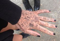 two people with their hands covered in tattoos