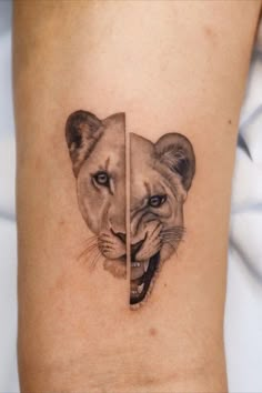 a lion and cub tattoo on the left side of the arm, with one facing each other