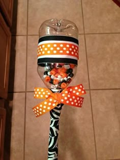 a candy filled lollipop with orange and black polka dots