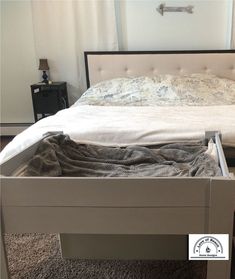 the bed is made and ready to be used as a nightstand or night stand for storage