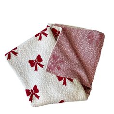 two red and white napkins on top of each other, one with a bow