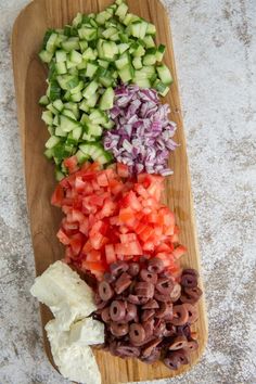 chopped up vegetables on a cutting board ready to be cut into bite sized pieces for salad