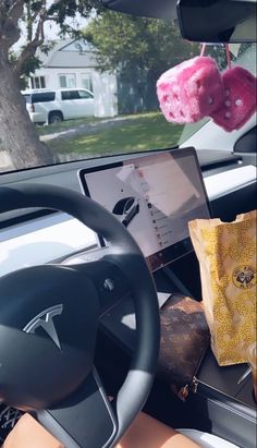 the interior of a car with a stuffed animal hanging from it's dash board