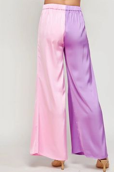 Color block Satin Wide Palazzo pants. These trousers feature elasticated waist at back for comfort, side pockets, wide legs, front pleats, and color block construction. 100% polyester. *Available at our Rehoboth Beach location or Online. Summer Wide Leg Pants With Contrast Color, Two-tone Color Block Bottoms For Spring, Spring Two-tone Color Block Bottoms, Summer Color Block Wide Leg Pants, Summer Color Block Wide-leg Pants, Wide Leg Color Block Pants For Summer, Chic Color Block Bottoms For Spring, High Waist Pants With Contrast Color, Chic Spring Color Block Pants