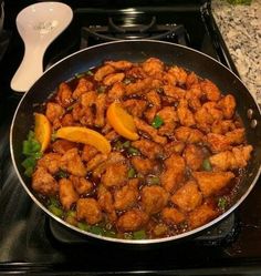 a pan filled with meat and vegetables on top of a stove