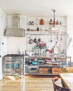 a kitchen filled with lots of clutter and cooking utensils